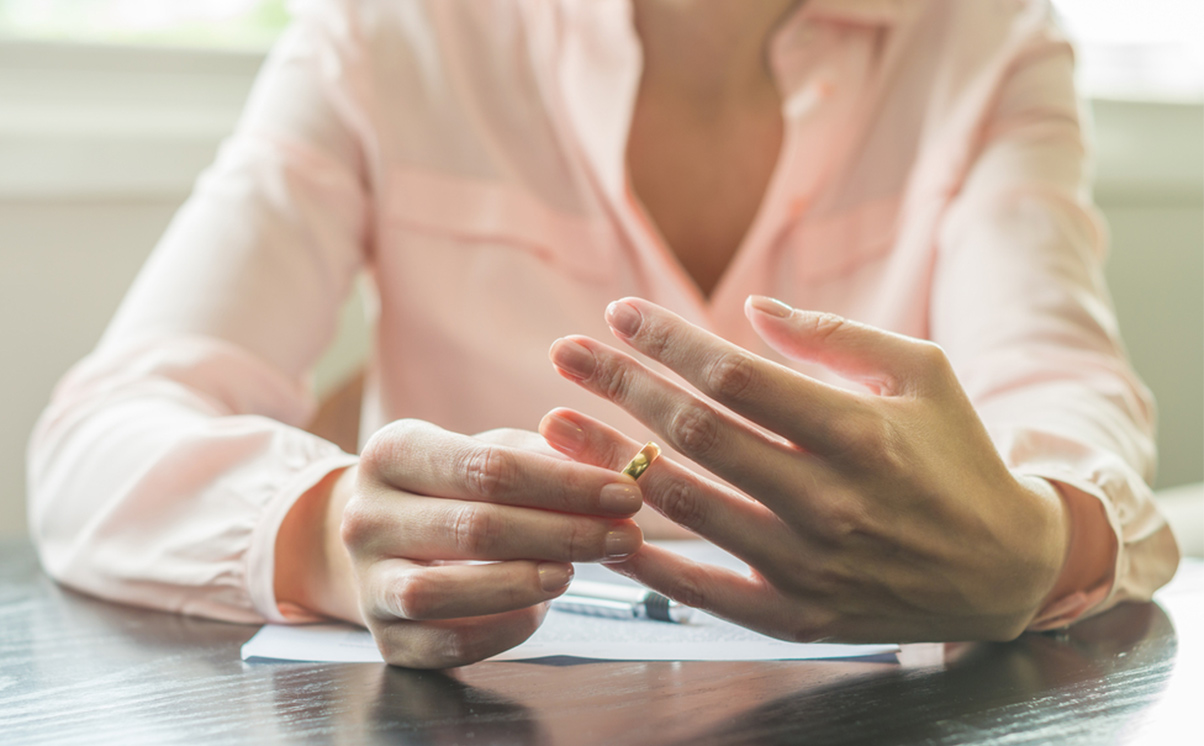 Divorce - Woman taking off wedding ring